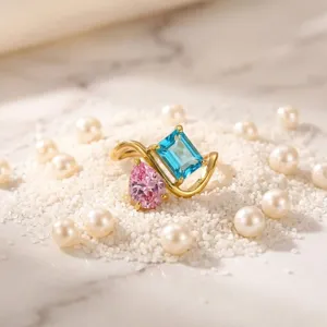 Gold plated titanium steel ring detailed shot with blue and pink cubic zirconia gemstones.