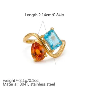 Detailed view of the asymmetric stainless steel gold-plated ring with dual colorful gemstones.