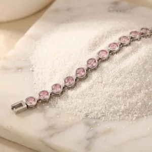 Pink cubic zirconia tennis bracelet detail shot, elegant stainless steel wrist jewelry for women.