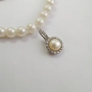 Pearl necklace pendant clasp, DIY jewelry accessory featuring micro-pave metal bail and pearl details.