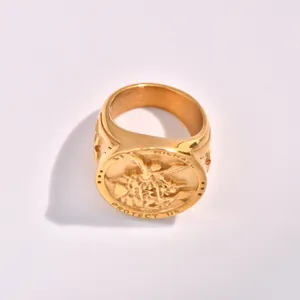 Detailed close-up of men stainless steel signet ring with Saint Michael engraving in gold finish.