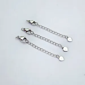 Silver extension chain detail view showing lobster clasp and heart pendant design.