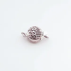 Detailed shot of a white gold plated hollow metal clasp for DIY pearl necklaces and bracelets.