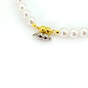 Closeup of magnetic pearl necklace clasp, gourd peanut shape metal strong magnetic fastener.