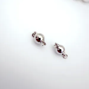 Close-up detail of silver round ball screw clasps for DIY pearl necklaces and bracelets.