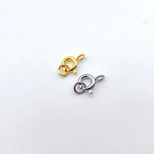 Close-up of gold and silver spring clasps for jewelry making, durable metal necklace links.
