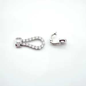 Close-up detail of silver zircon horseshoe clasp, DIY pearl necklace bracelet connector parts.
