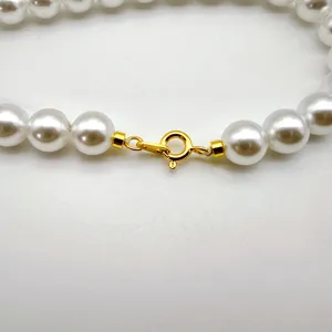 Gold plated spring clasp detail for pearl necklace, secure jewelry finding component part.