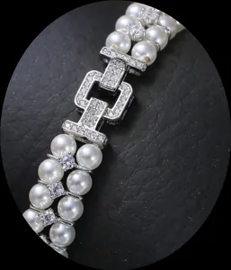 Close-up detail of double-row pearl bracelet clasp, paved with sparkling cubic zirconia.