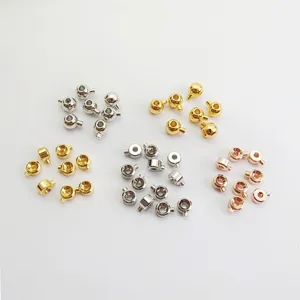 Small metal jewelry clasps and positioning beads for DIY handmade bracelets and necklaces.