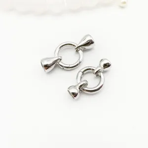 Detail shot of silver tone round inner spring clasp and end caps for DIY jewelry making.