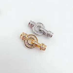 Close-up detail of double cubic zirconia OT clasps for DIY jewelry making, silver and gold.