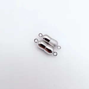 Detailed view of the peanut-shaped magnetic clasp, metal jewelry connector for pearl necklaces.