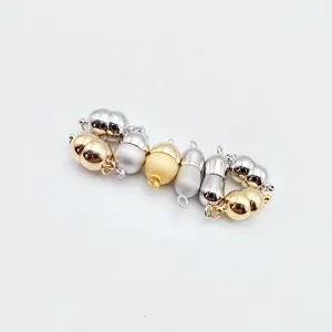 Close-up detail of metal magnetic clasps for pearl necklaces and bracelets in various finishes.