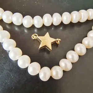 Pearl necklace detail with gold star magnetic clasp accessory, premium jewelry making part.