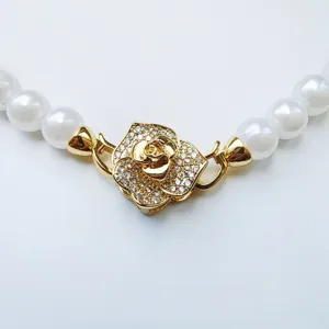 Rose rhinestone necklace clasp detail, gold plated double lock clasp with white pearls accessory.