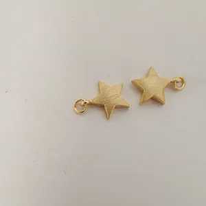Gold star charm detail close up, shiny metal pendant component for DIY jewelry accessory making