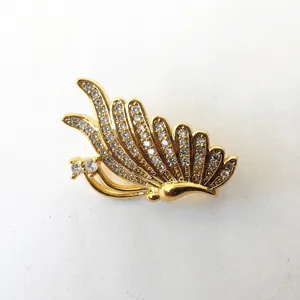 Gold tone micro pave crystal feather shape jewelry clasp and brooch accessory detail.