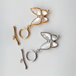 Close-up detail of butterfly mother-of-pearl OT toggle clasps for jewelry making, gold and silver.