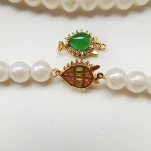 Pearl necklace clasp detail, micro-set green jade and gold-plated DIY jewelry connector accessory.