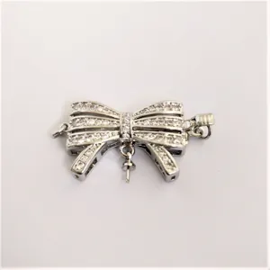 Detail shot of DIY silver tone pave cubic zirconia bow jewelry connector clasp for necklace.
