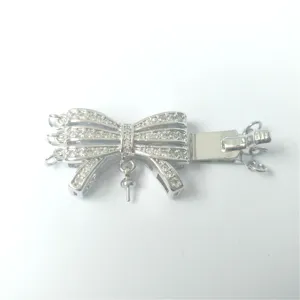 Close-up details of DIY micro-pave zirconia bow multi-strand necklace clasp connector.
