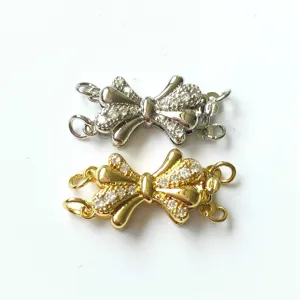Close-up detail of multi-strand bow necklace clasp, rhinestone inlaid jewelry DIY findings.