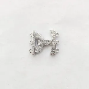 Close-up detail of silver tone multi-strand zirconia paved jewelry clasp connector accessory.