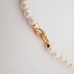 Detail shot of a delicate gold plated micro pave clasp for pearl jewelry DIY projects.