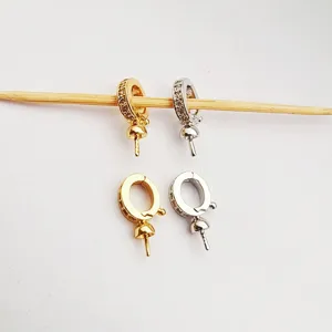 Detail view of copper-plated cubic zirconia jewelry pendant bails and universal pearl necklace connectors.