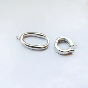 Close-up of silver metal jewelry clasps and DIY connectors for custom necklaces and bracelets.