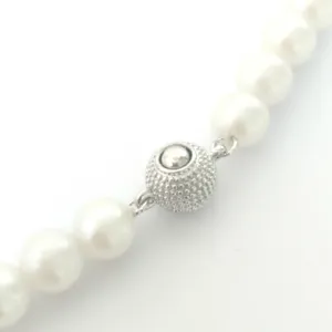 Pearl necklace round textured metal ball clasp accessory close-up detail product shot