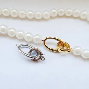 DIY metal jewelry clasp, gold and silver interlocking necklace clasp with white faux pearls.