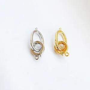 Metal jewelry clasp detail, shiny gold and silver interlocking links for DIY craft making