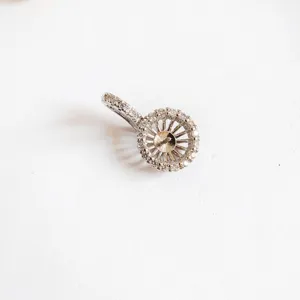Close-up detail of DIY metal micro-paved pendant bail clasp for pearl necklace making.