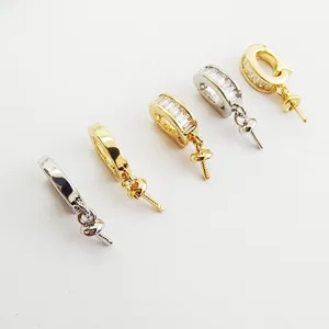 Detailed view of DIY zirconia crystal pendant bails and pearl connectors for custom necklaces.
