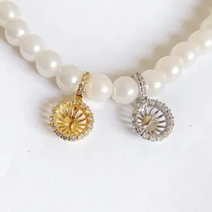 Close-up detail of DIY jewelry pearl necklace clasp, metal micro-pave zirconia connectors.