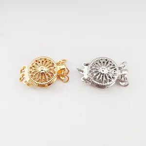 Detailed view of gold and silver sunflower jewelry clasps, perfect for DIY pearl necklaces.