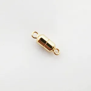 Close-up detail of the gold-plated magnetic jewelry clasp, showing the smooth cylindrical finish.
