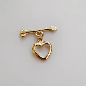 Gold-plated metal arrow and heart charm connector clasp detail for handmade jewelry DIY crafts.