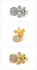 Detail view of magnetic jewelry clasp featuring paved zirconia clover and round crystal elements.
