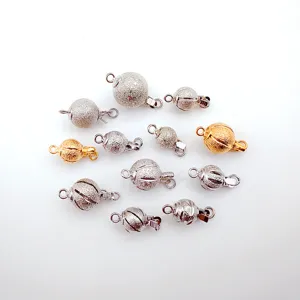 Close-up detail of frosted ball jewelry clasps, silver and gold metal DIY necklace and bracelet find.