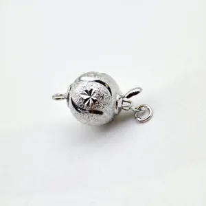 Silver tone ball clasp detail shot, sparkling frosted surface with carved star pattern DIY.