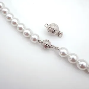 Detailed shot of sparkling matte spherical clasp for DIY pearl necklaces, bracelets, and chains.
