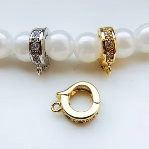 Detailed view of DIY jewelry universal clasps, gold and silver micro pave crystal connectors.