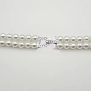 Pearl necklace double strand metal clasp detail shot with shimmering micro set cubic zirconia.