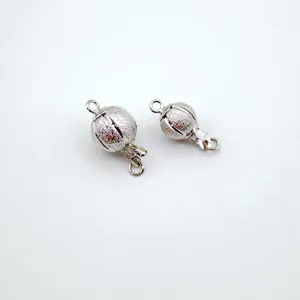 Close-up of silver glitter spherical jewelry clasp, ideal for DIY necklaces and bracelets.