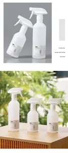 Detailed view of white plastic trigger spray bottles, showing fine mist nozzle and capacity.