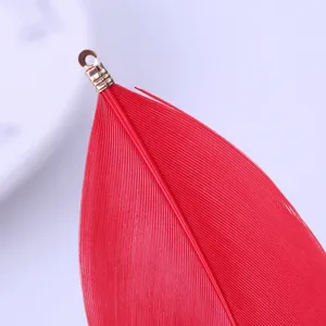 Red feather DIY jewelry accessory with metal clip pendant charm for handmade craft creation.