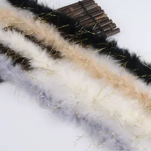 Detailed shot of colorful feather trim with gold tinsel for crafts and gift wrapping.